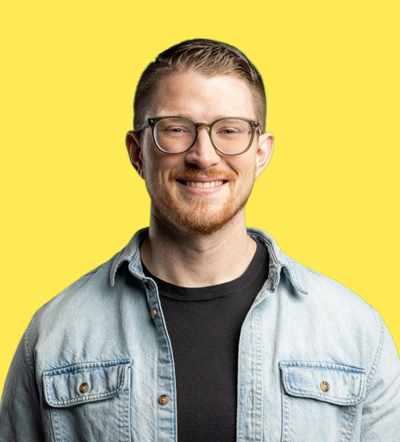 Man with glasses smiling in denim shirt at Smart Marketer LIVE 2026