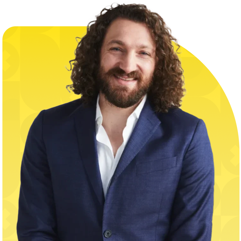 Man with curly hair in a suit at the Smart Marketer LIVE 2026 marketing conference.