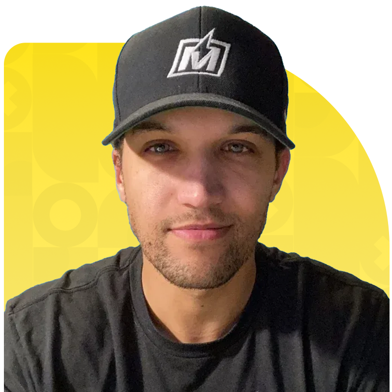 Man wearing a black baseball cap with a white logo, smiling